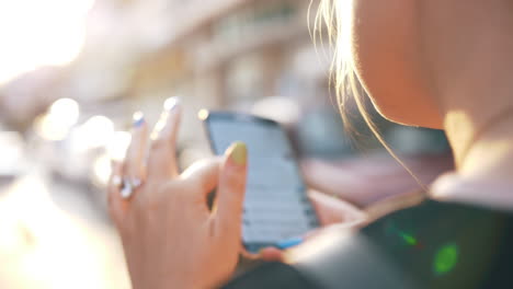 Woman-in-the-street-browsing-social-media-on-mobile