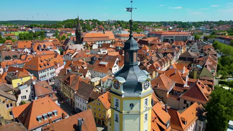 4k aerial drone video of the historic herrieder clock tower in the old town area of downtown ansbach, germany