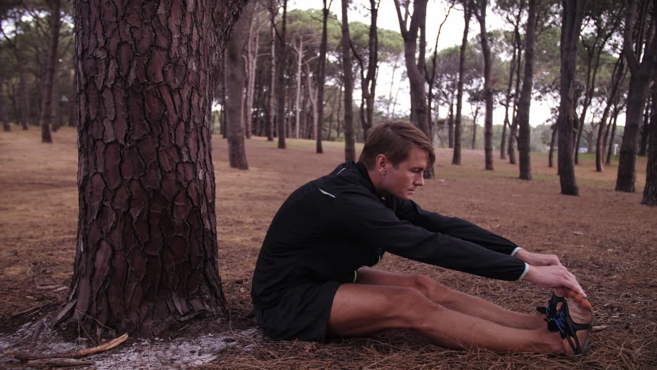 Pine Trees Surround Man Stretching Alone