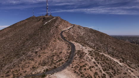 aerial dolly-in towards radio towers on top of mountain near el paso, tx