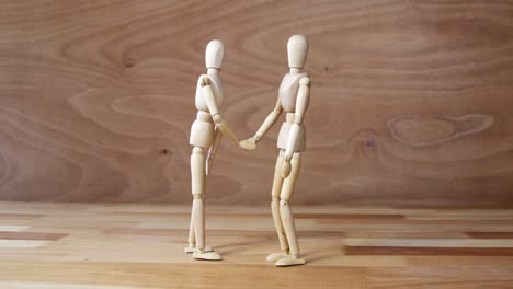 business figurine shaking hands during meeting