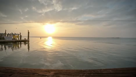 time lapse of a tranquil sunset over a pier on laguna madra near corpus christi, texas