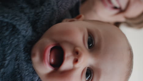 close up happy baby having video chat using smartphone mom sharing motherhood lifestyle holding toddler chatting with family on vertical screen pov