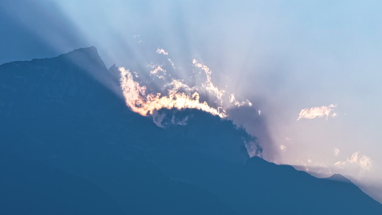 Timelapse Aerial view of sunrise behind Mount Everest silhouette with drifting clouds, peaceful and spiritual landscape at high Himalayan altitude tourism view majestic