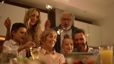 big family singing christmas song at camera during online video call