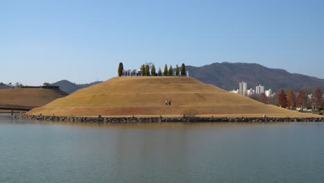 lake garden of suncheonman bay national garden with people walking on bonghwa hill - distant static landscape