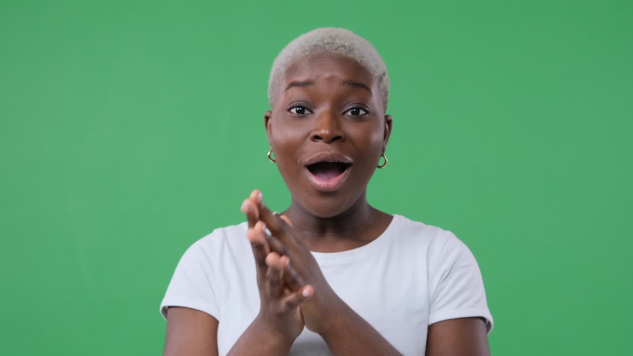 Amazed woman over green background