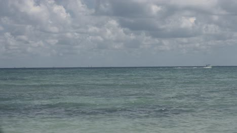 Static-shot-of-motor-boat-sailing-on-the-sea-on-cloudy-day