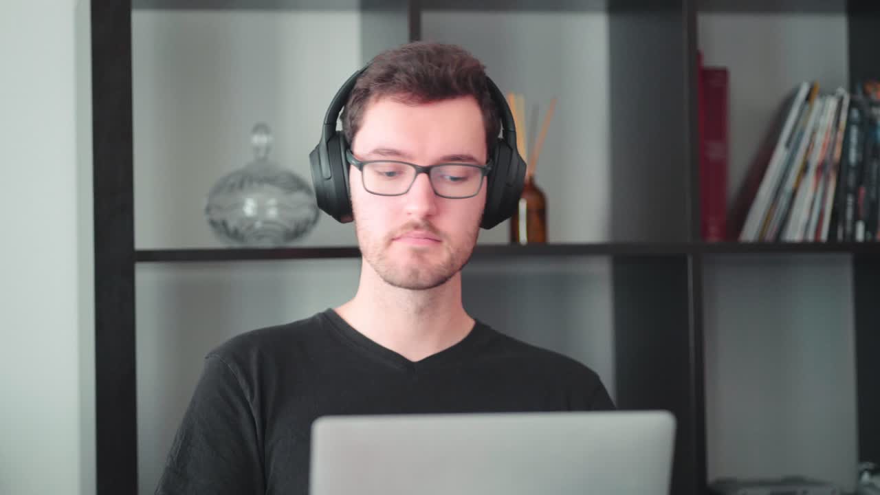 Young modern caucasian man home office worker college student learns laptop table at home