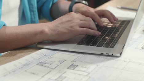 close up of hand's man engineer typing on a laptop at the office