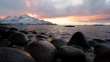 beautiful colors of setting sun above the fiord near tromvik in northern norway