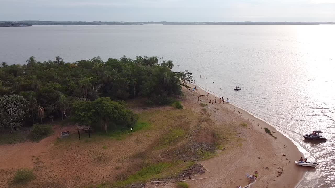 Rotational aerial shot over the small island &amp;quot;Isla del Medio&amp;quot; with boats and tourists on the coast