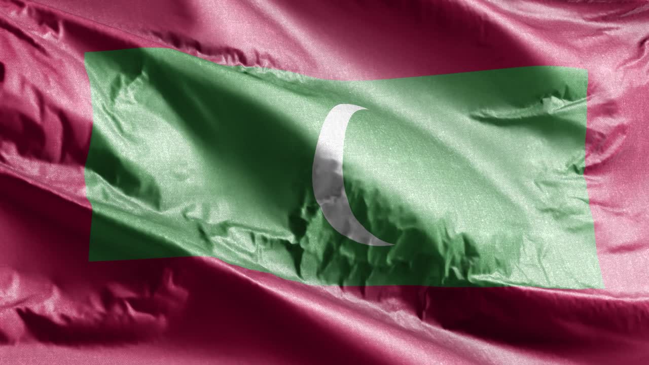 la bandera textil de las maldivas ondeando en el bucle del viento. la bandera de las maldives balanceándose en la brisa. el tejido textil de la tela. el fondo de relleno completo. bucle de 10 segundos.