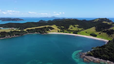 aerial fly-away shot a paradise looking beach in bay of islands, new zealand