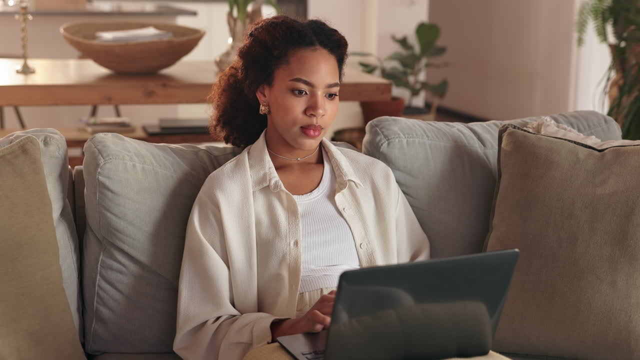 Woman Working on Laptop at Home