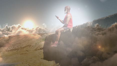 animation of glowing light over senior man using smartphone sitting on rock