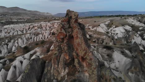 A-Mavic-Air-flies-around-an-high-peak-with-color-contrast-in-the-love-valley-near-Goreme-during-sunset--Kapadokya