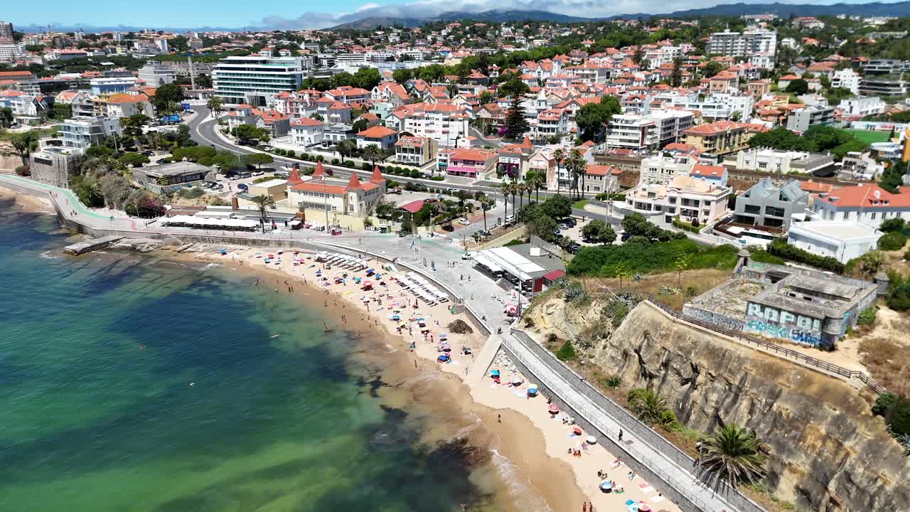 Aerial view of a coastal town with beach and architecture