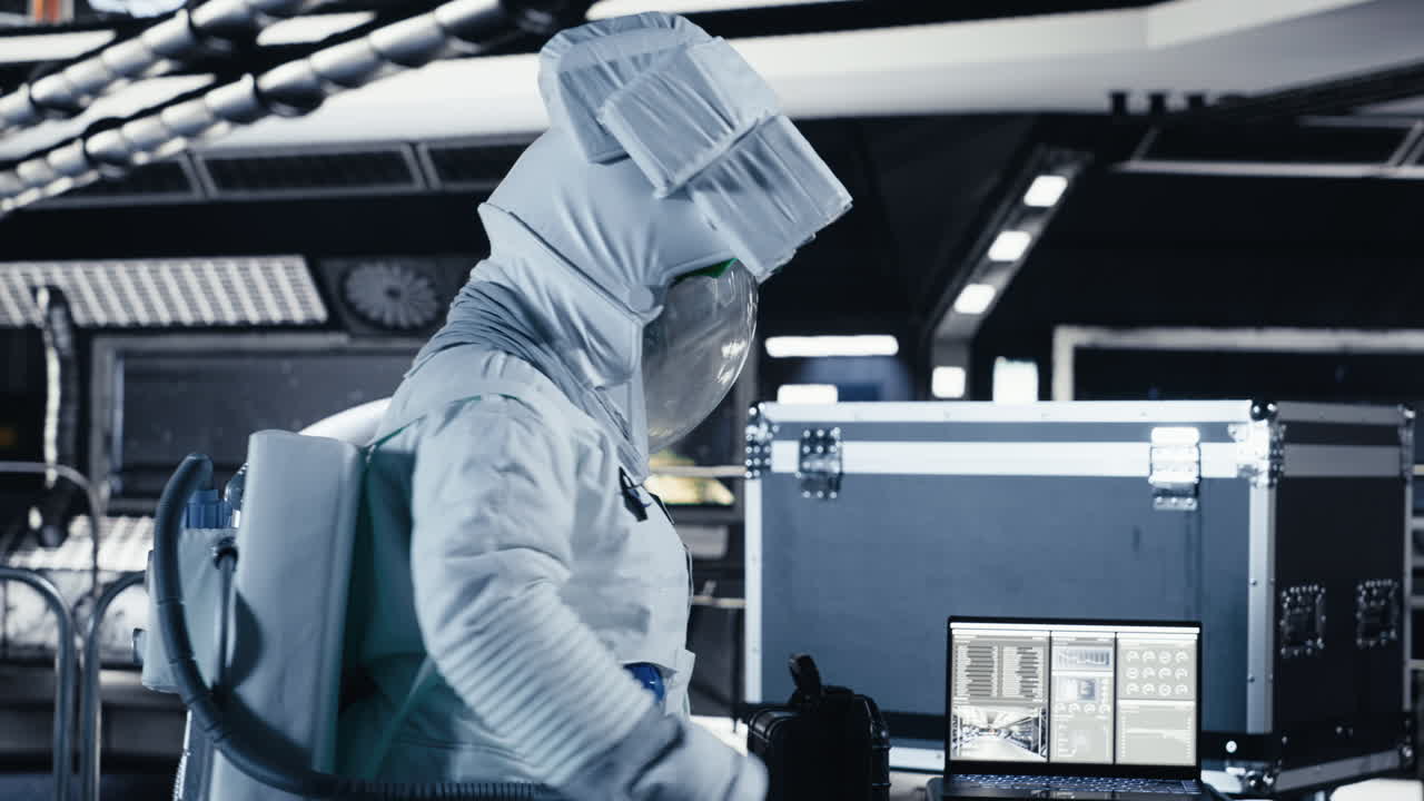 Astronaut enters spaceship cockpit with equipment case