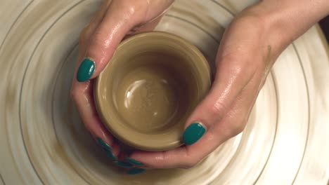 close up footage of woman making a pot cup, pottery work.