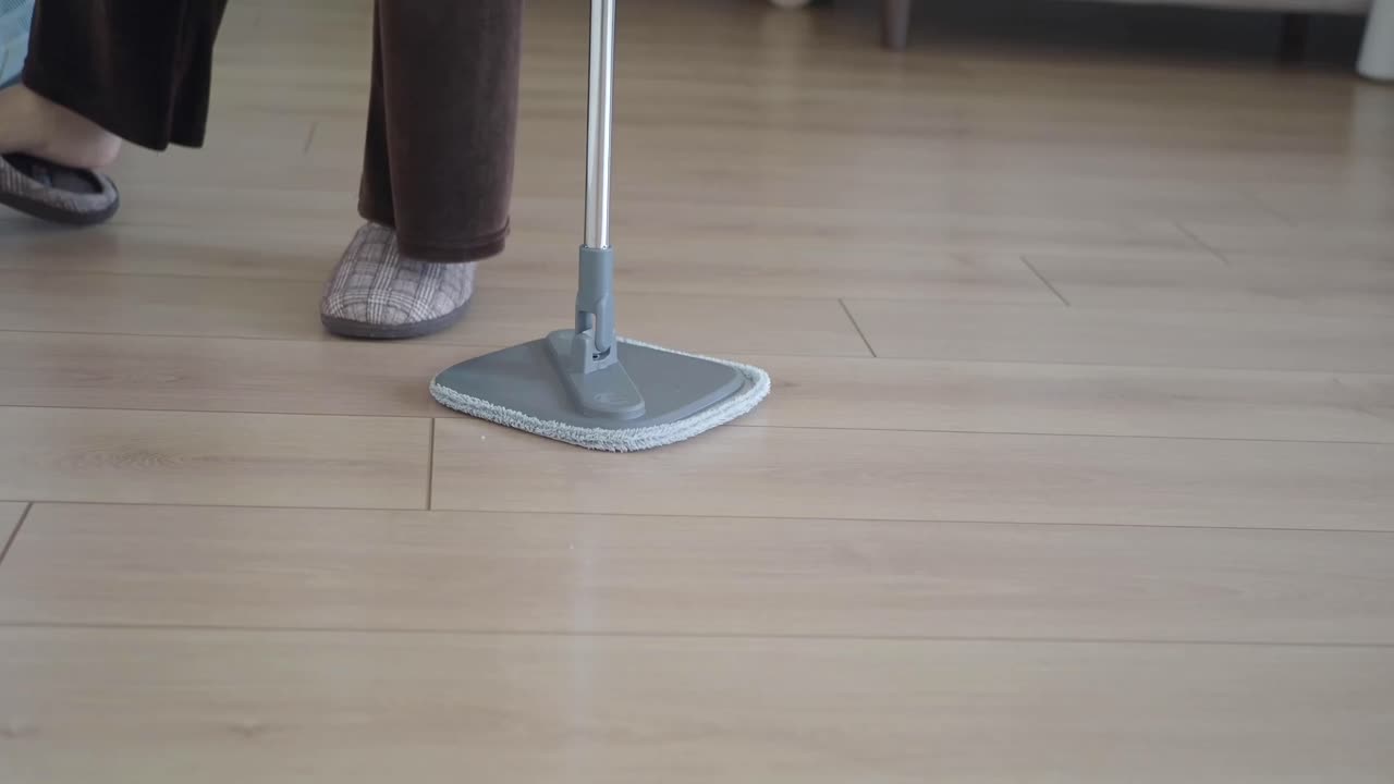 Cleaning a wood floor with a mop