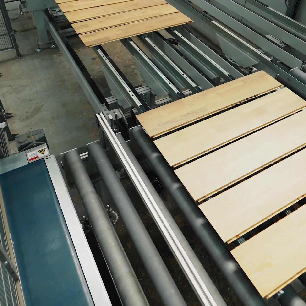 Floorboard production in the industrial factory. Manufacturing of a parquet board. Modern technologies.