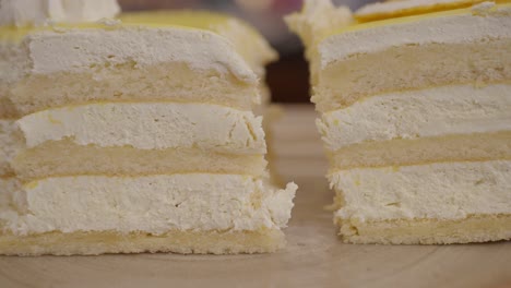 close-up of a sliced white cake with yellow frosting