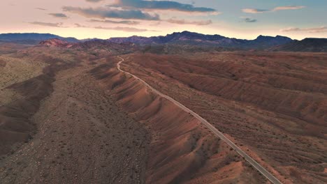 sweeping view of desert landscape showcasing a winding road and dry riverbed