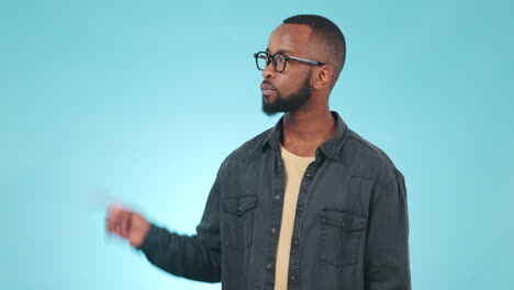doubt, pointing and face of black man in a studio