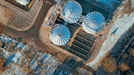 Aerial-footage-moving-towards-a-large-industrial-chemical-plant,-showing-pipelines,-metal-structures,-cooling-towers-and-chemical-storage