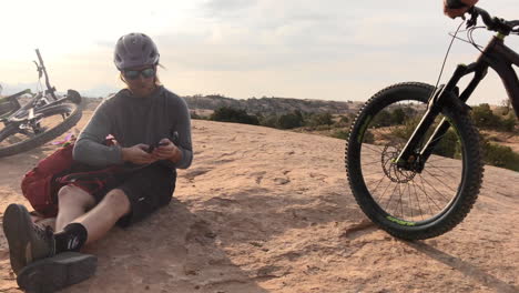 an athletic mountain biker resting