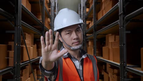 warehouse worker giving stop signal