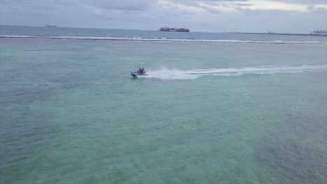 Vista-Aérea-of-two-men-riding-a-jet-ski-in-the-Boca-Chica-beach-region-of-the-Dominican-Republic