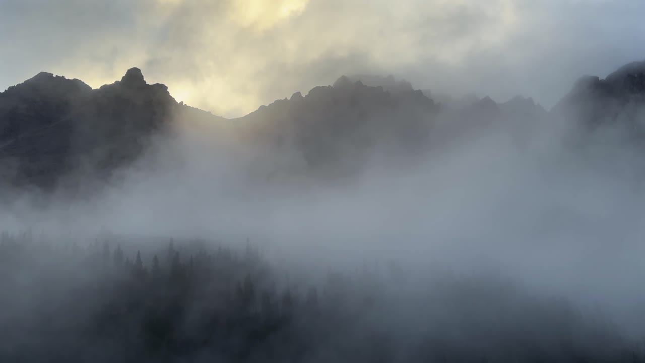 Foggy rain misty cloudy golden hour early morning sunrise sunset Rocky Mountains Colorado Pyramid Peak Maroon Bells Wilderness Aspen Snowmass fourteener White River National Forest pan left motion