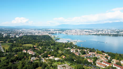parallax drone shot of water fountain of geneva and lake leman during the day (rade of geneva) from cologny, switzerland