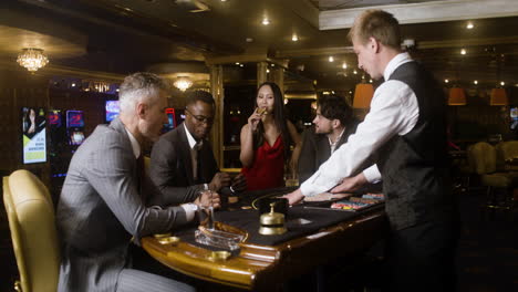 multiethnic group of people at the poker table in the casino.