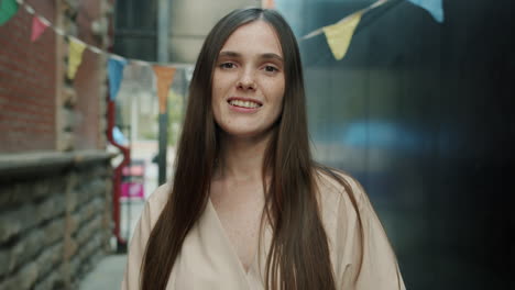 woman smiling in urban alleyway