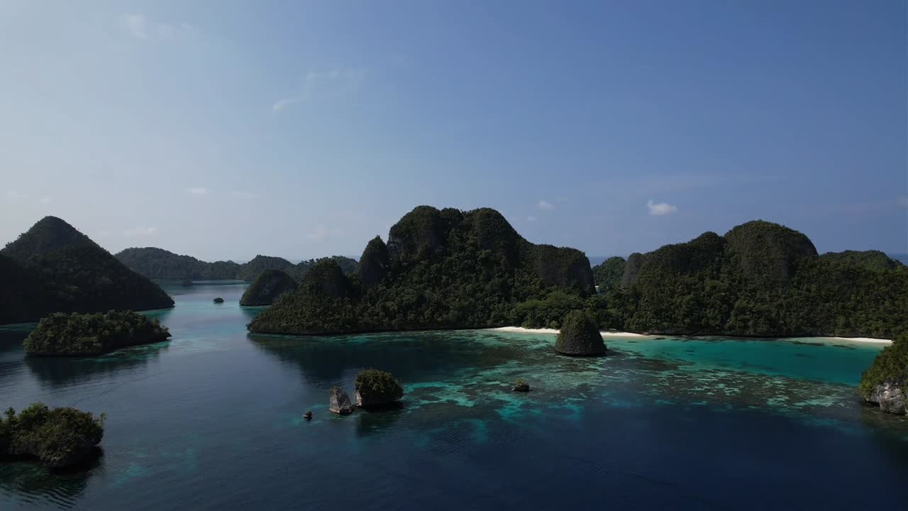 Flying towards paradise island with white sand beach in Raja Ampat, Wayag, Indonesia