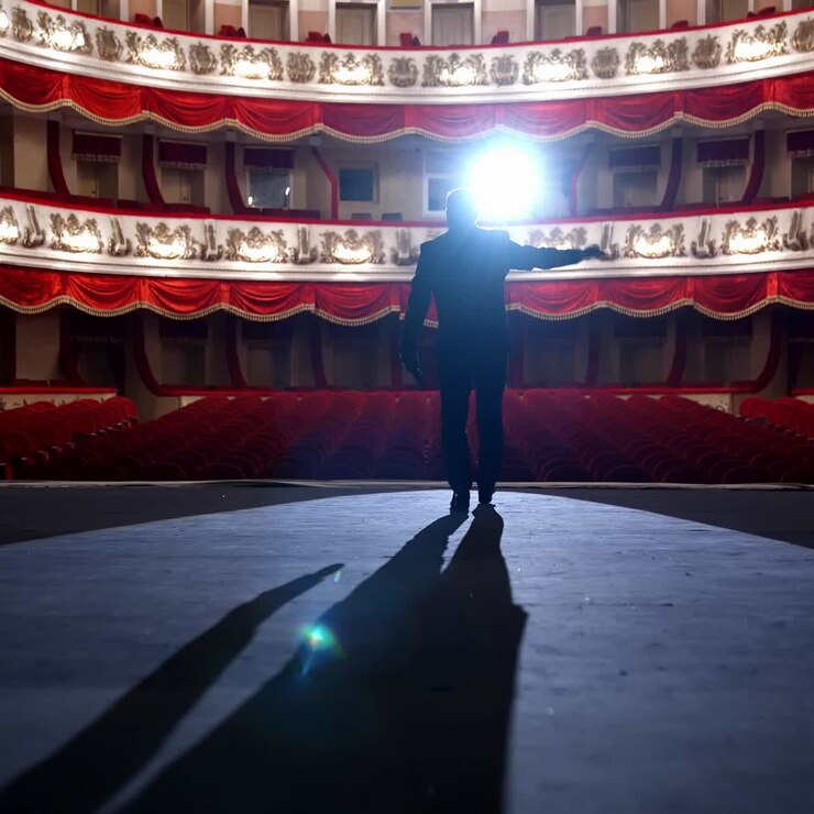 Empty raws in theater. Actor bows down in front of empty auditorium. Cancellation of mass events to prevent spread of coronavirus infection