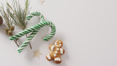 Video-of-christmas-decoration-with-gingerbread-man-and-copy-space-on-white-background