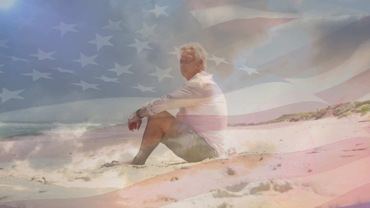 Animation of senior caucasian man sitting on beach over flag of united states of america