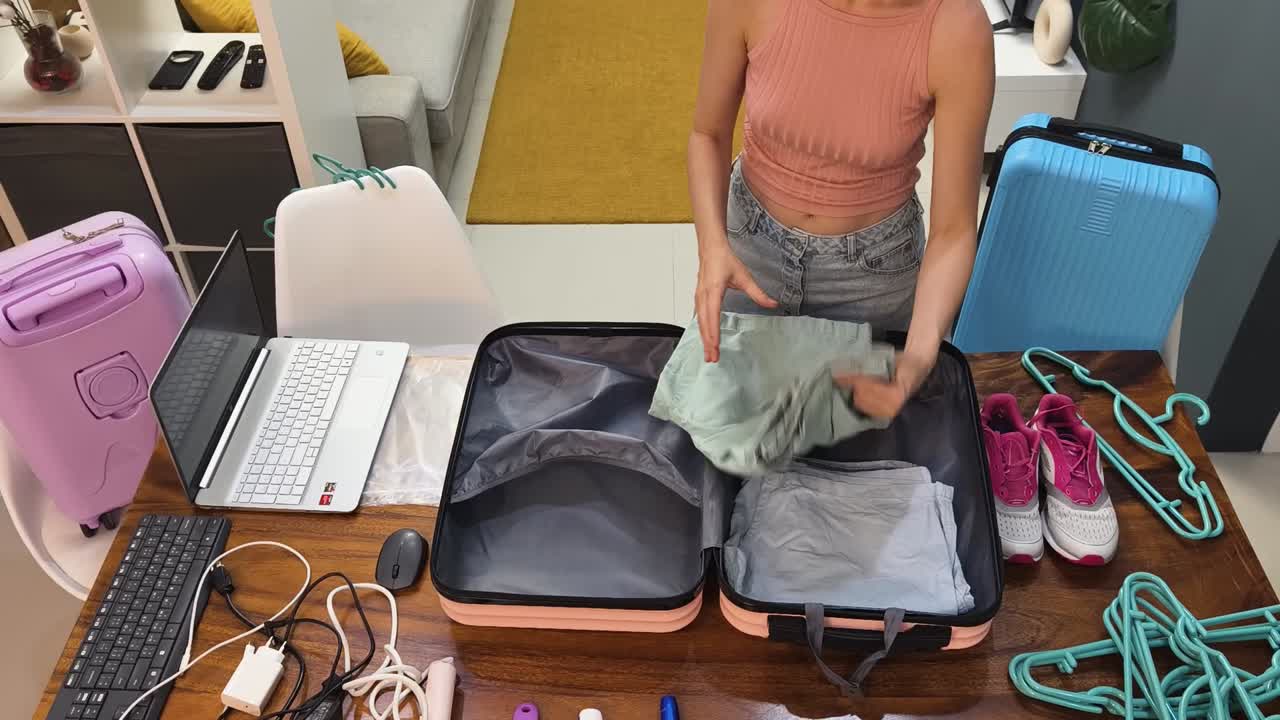 Woman packing her suitcase for travel