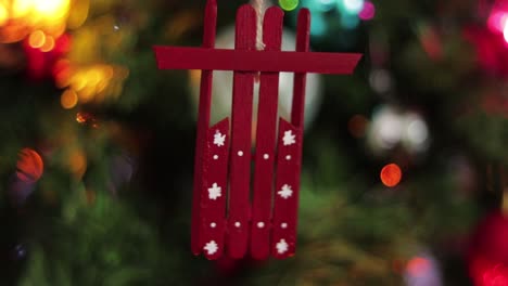 red snow sled hanging, made of popsicle sticks