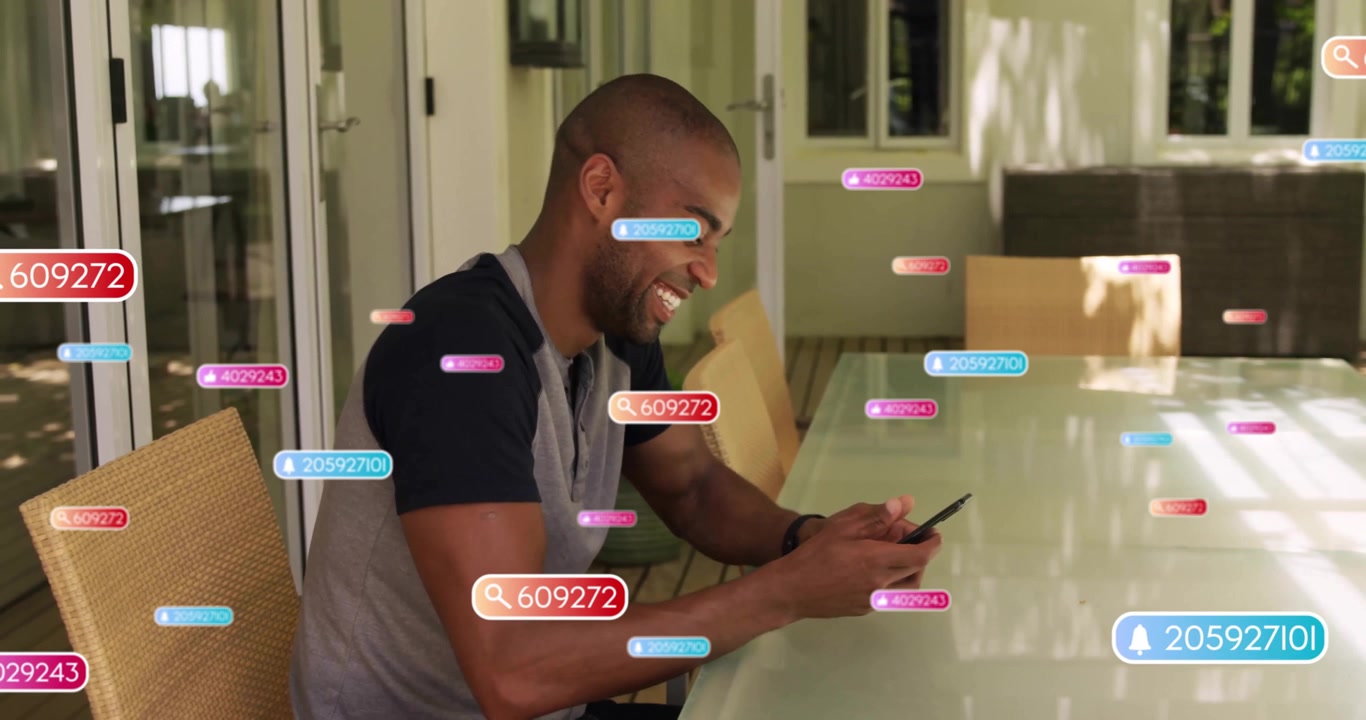 Man tapping smartphone on patio table, generating floating notification badges for social updates