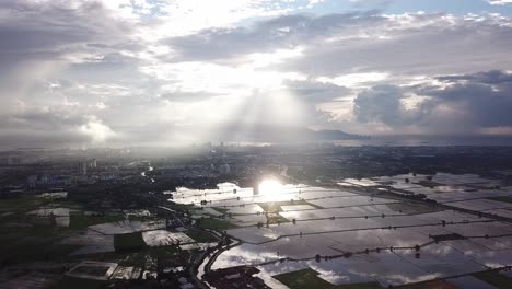 beautiful sun ray over reflection in flooded paddy field.