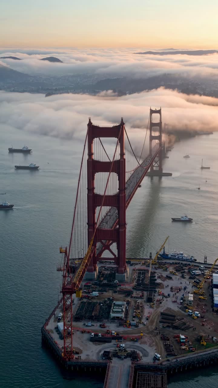 Aerial video captures the iconic bridge shrouded in mist, with a high-angle view
