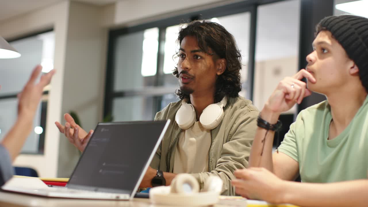 Diverse peers seeing left speaker gesturing, man shifting, clarifying point, raising palm by laptop