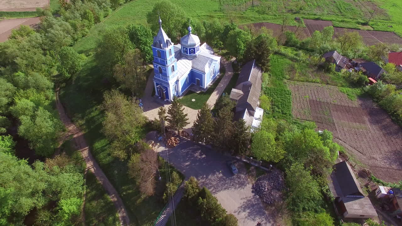 Little Orthodox church built more than a century ago. Religious building in the rural area of Ukrainian outback. Aerial perspective.