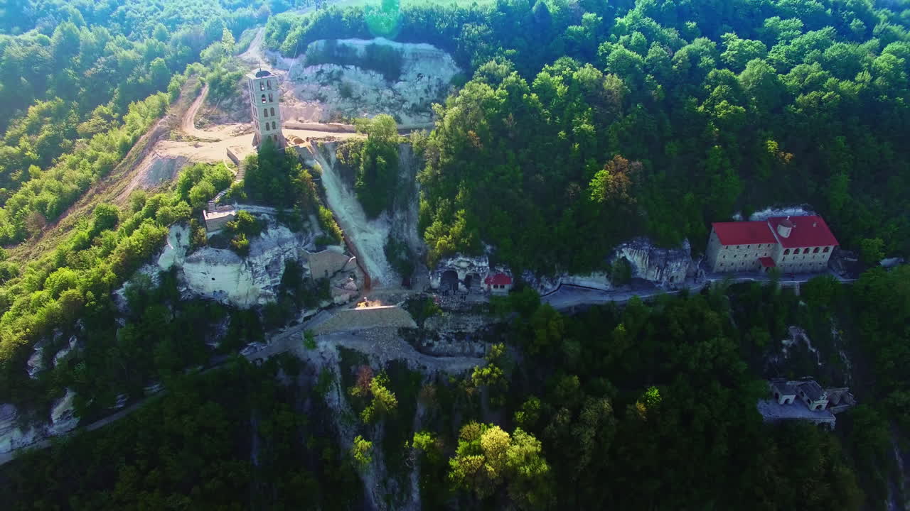 Bell tower on the top of the mountain. Liadova Rock Monastery from drone footage on sunny summer day.