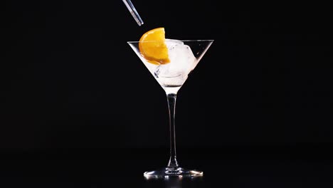 orange slice placed on ice in glass